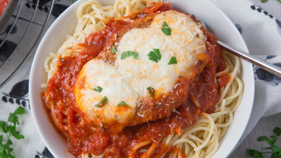 Hungry for more? Authentic Italian Chicken Parmigiana - crispy breaded chicken topped with hearty tomato sauce, melted cheese, and herbs. An easy dinner, with tons of flavor, and perfect for leftovers! One of the BEST chicken parmesan recipes.