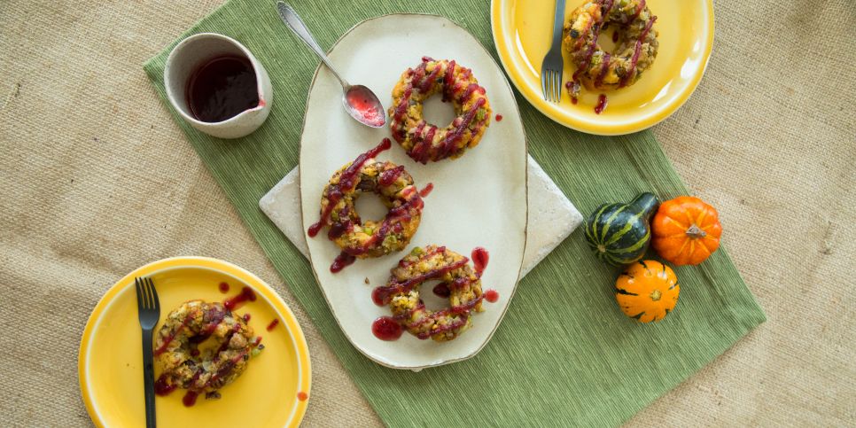 Donuts made out of Thanksgiving leftovers stuffing on a plate with cranberry jam