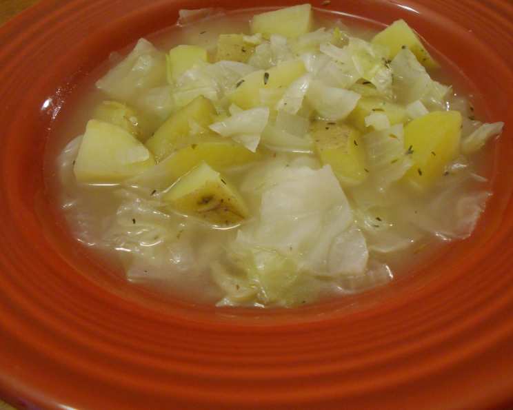 Cozy cabbage soup with fresh herbs and vegetables