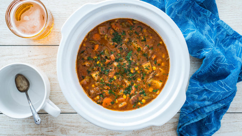 Traditional old fashioned beef stew in a white bowl showing chunks of beef and celery.