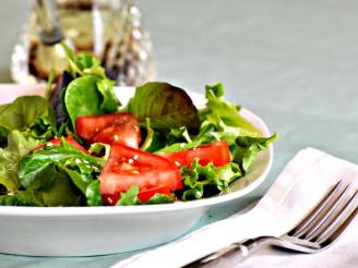 A Salad of Arugula (Rocket), Cherry Tomatoes and Sesame Seed